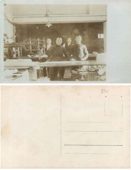 Tailor's sewing room with sewing machines and cutting table real photo card * ca. 1930
