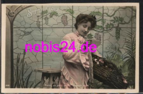 Woman with flower box reads letter *ca.1910