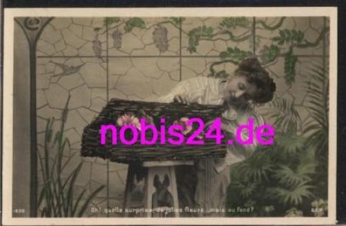 Woman looks into a flower box * around 1910