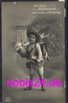 First school year boy with a bag of sugar satchel greetings card *ca.1913