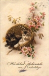 Cats sitting in a basket with a cherry branch, o 1.3.1929