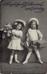 Children with packages and a bouquet of flowers Birthday card Gebr. circa 1910